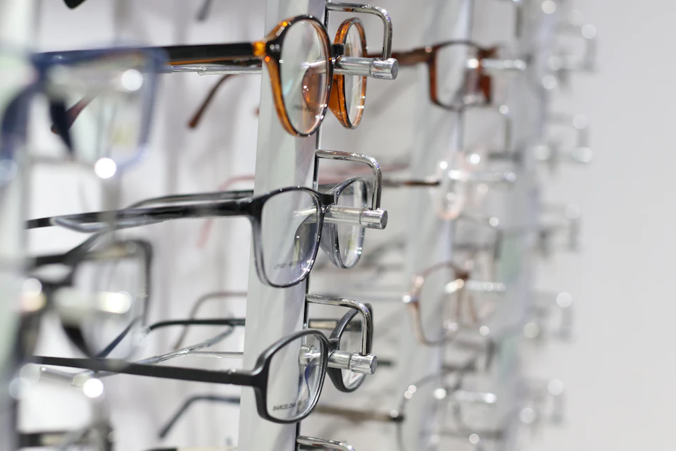 Silver framed eyeglasses on clear glass