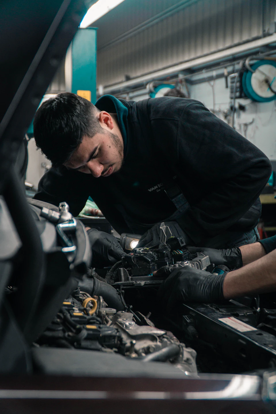 Mechanic working on car engine
