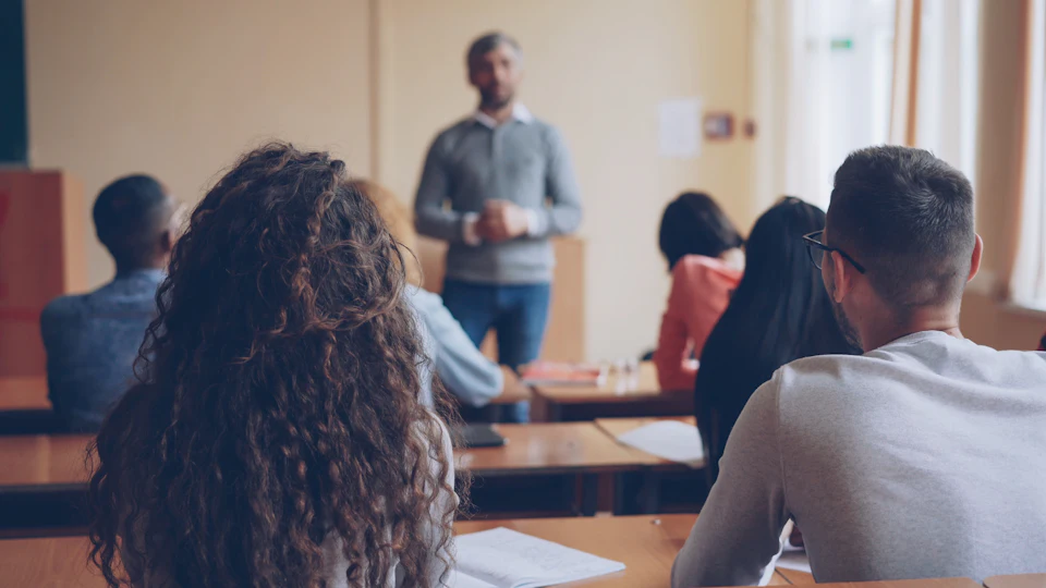 Teacher instructing students in a classroom setting